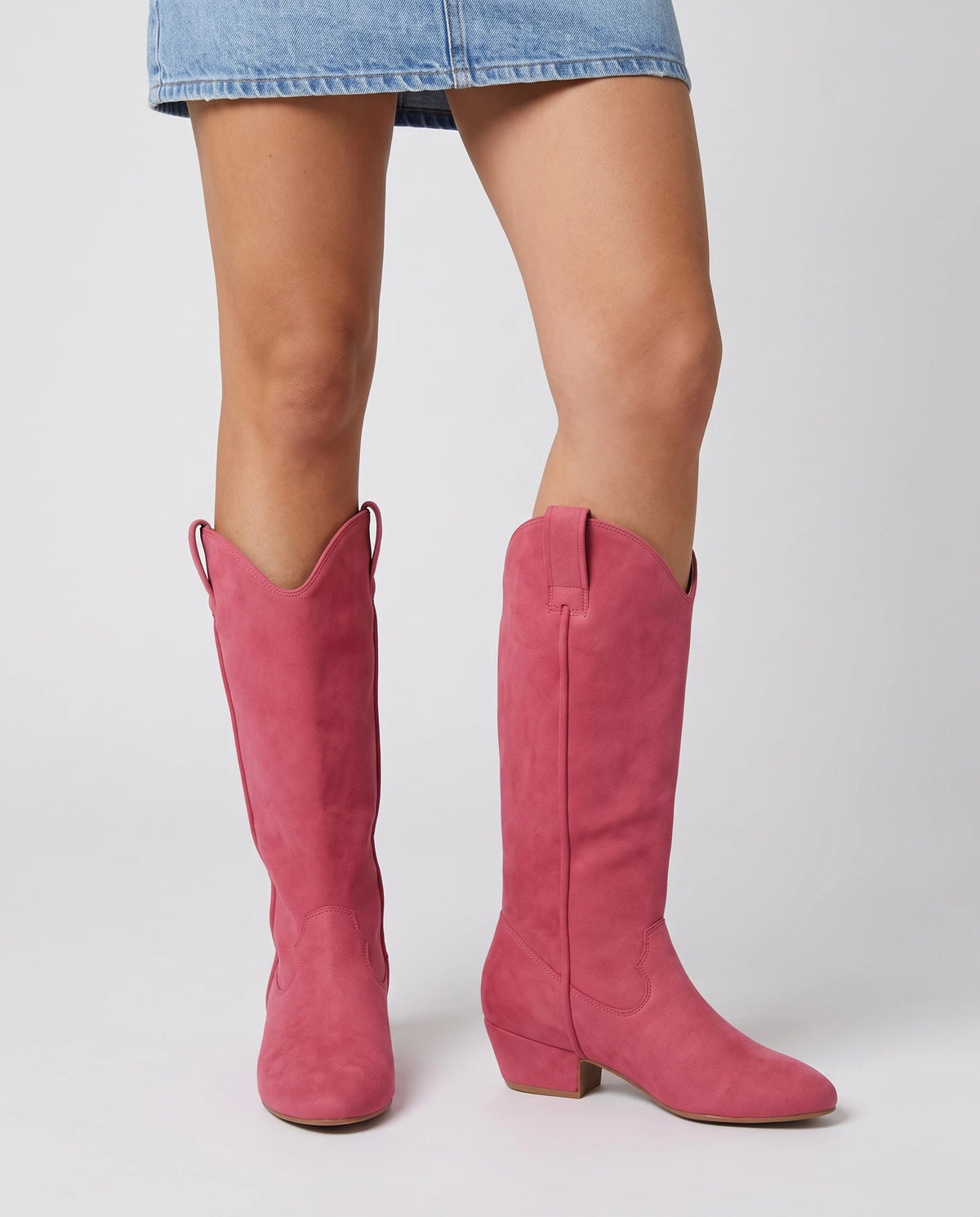Bottes hautes western en suédine Marjolaine — Rose Framboise, portées en plan rapproché avec une robe courte