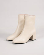 Bottines zippées en simili brillant Reine — Crème, paire en packshot studio