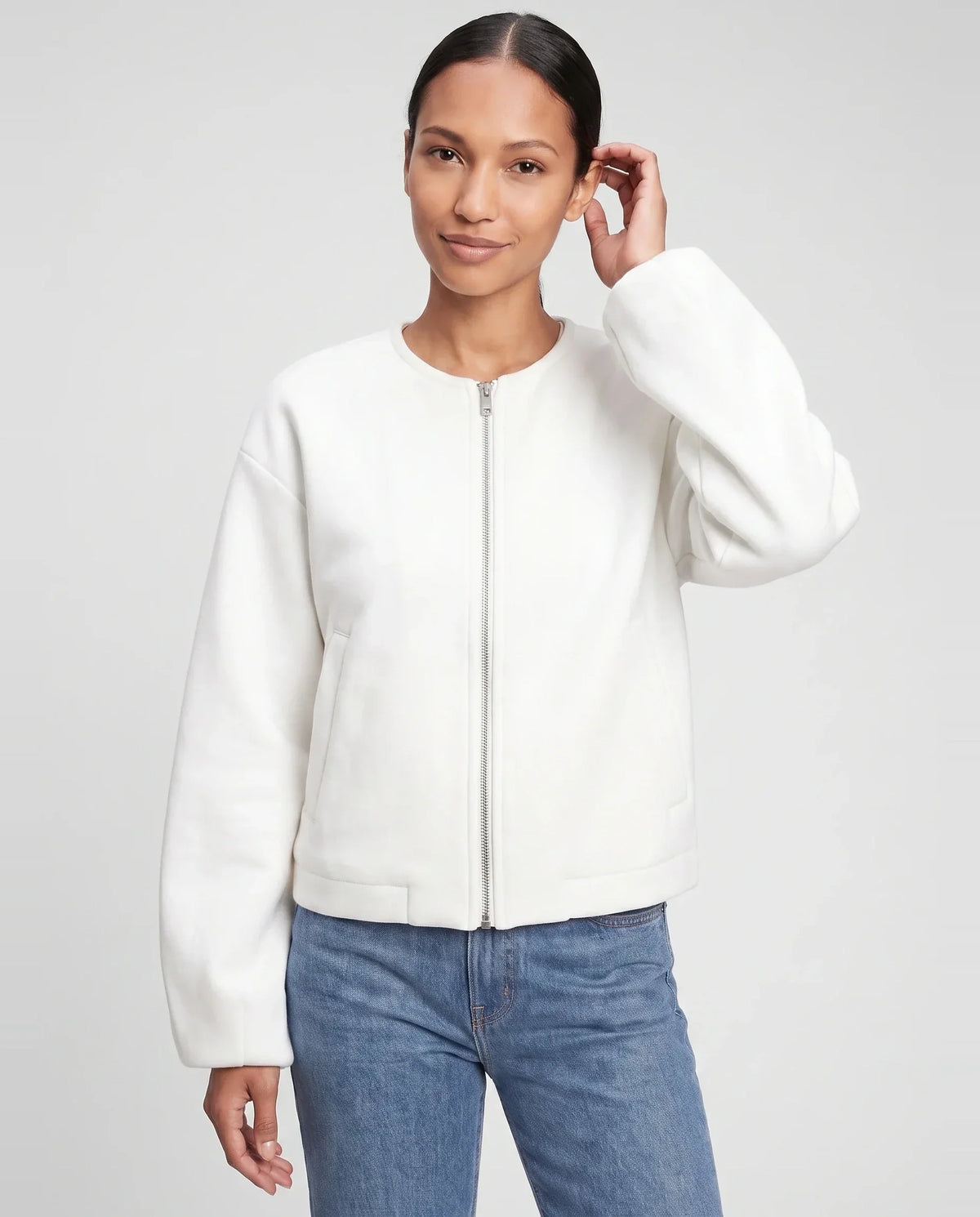 Veste zippée sans col en maille blanche Capucine, plan rapproché en studio