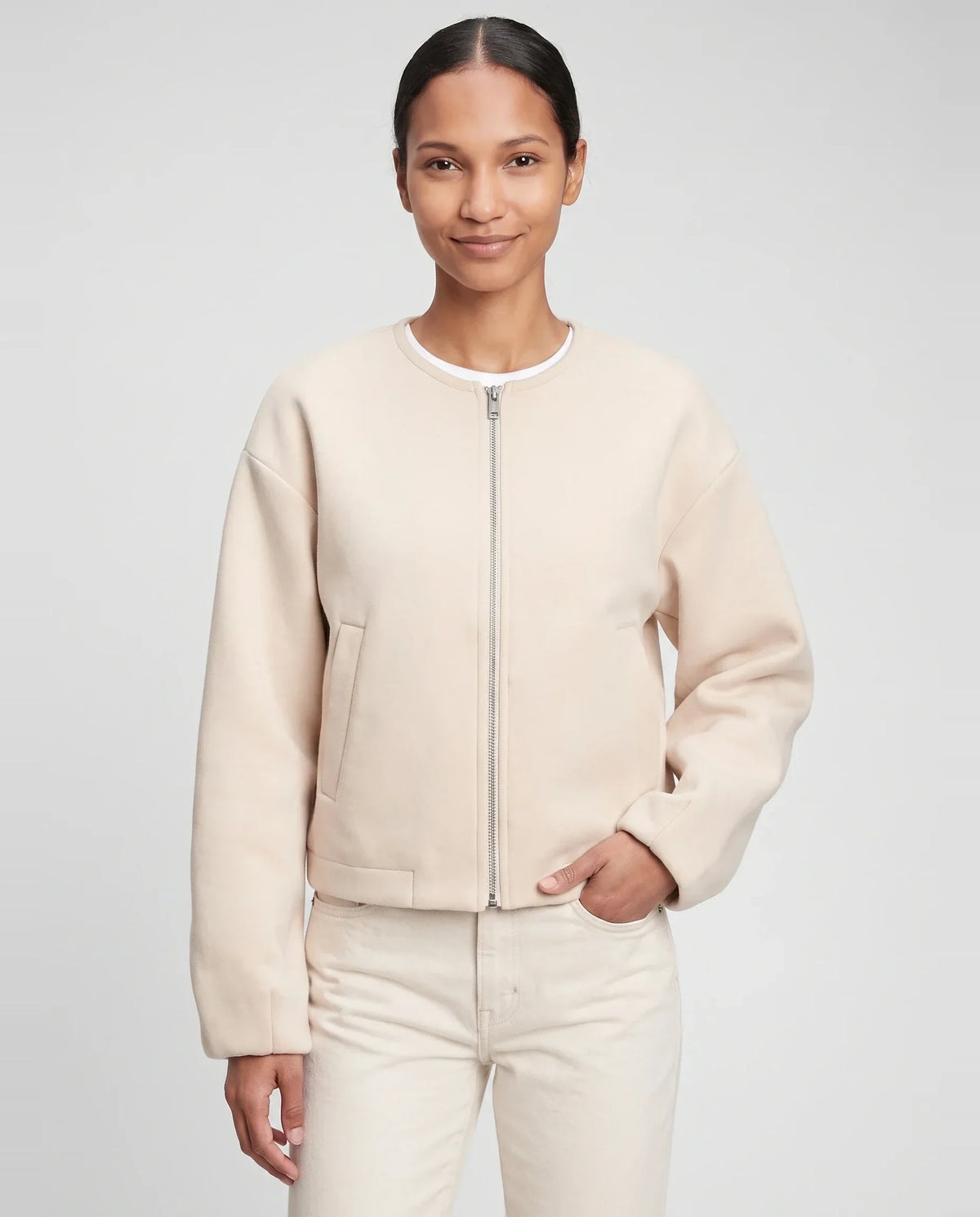 Veste zippée sans col en maille crème Capucine, plan rapproché en studio